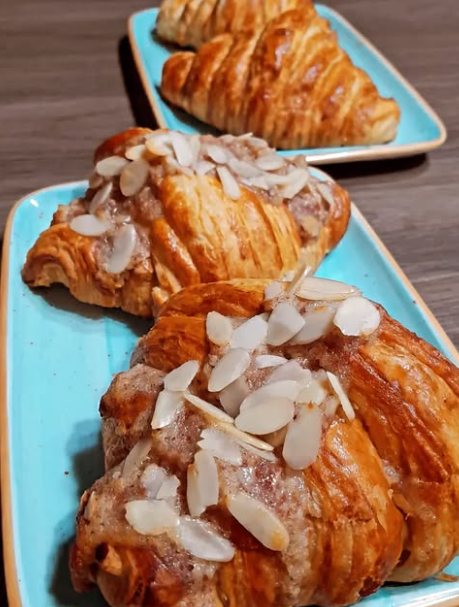 Almond croissants on turquoise plates