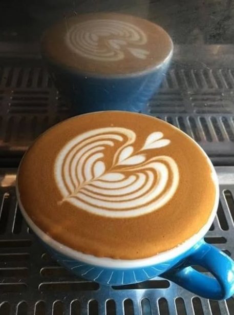 Latte art in a blue cup